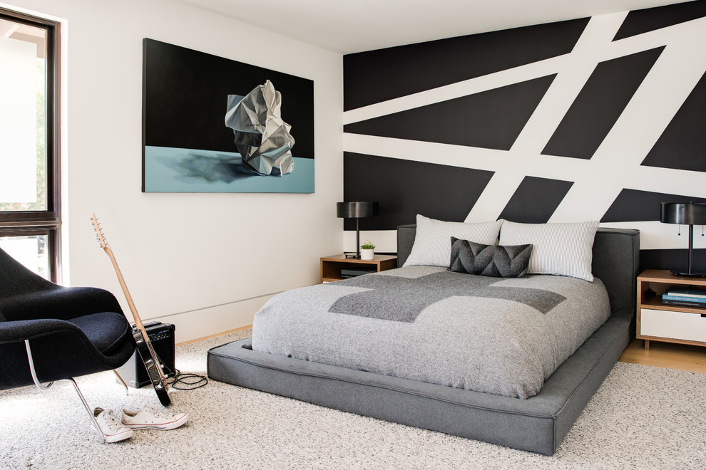 Example of a trendy boy medium tone wood floor and brown floor kids' room design in San Francisco with black walls