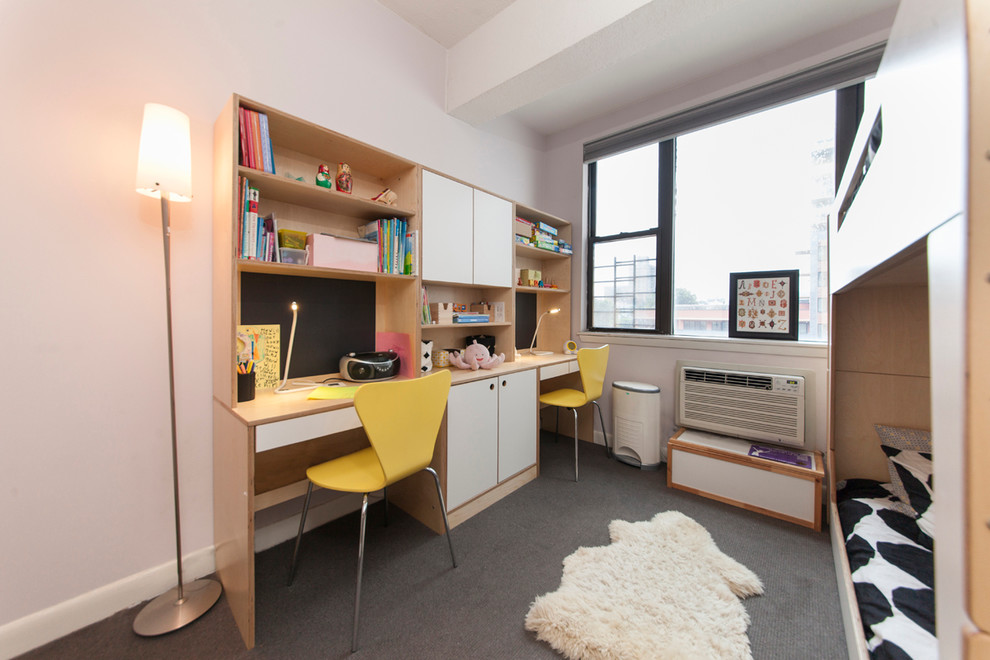 Inspiration for a small modern girl carpeted kids' room remodel in New York with white walls