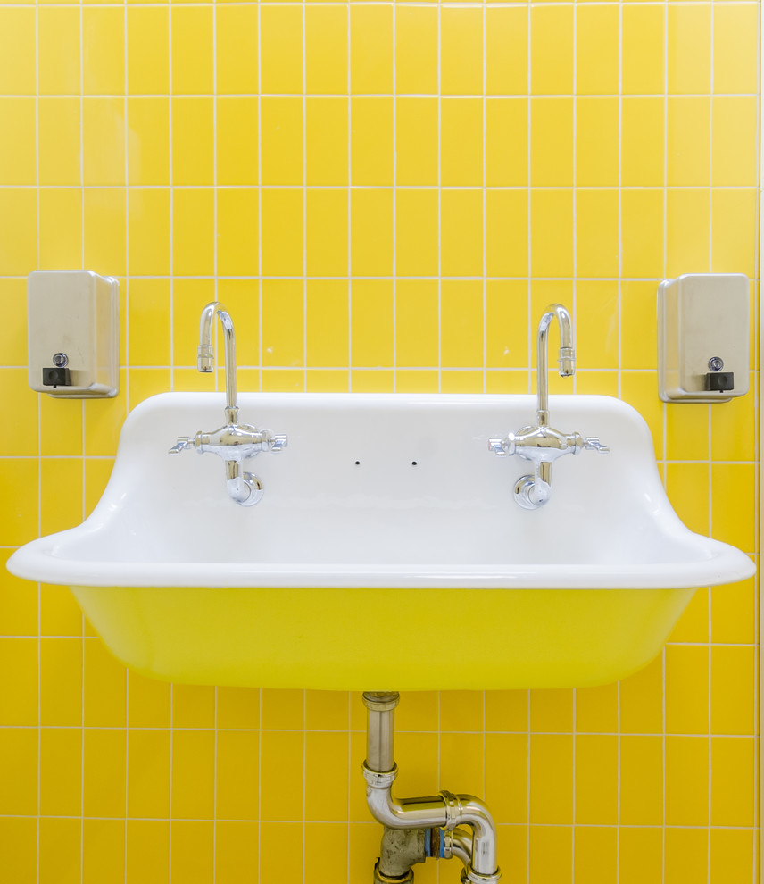 Small trendy laminate floor and beige floor bathroom photo in New York with yellow walls