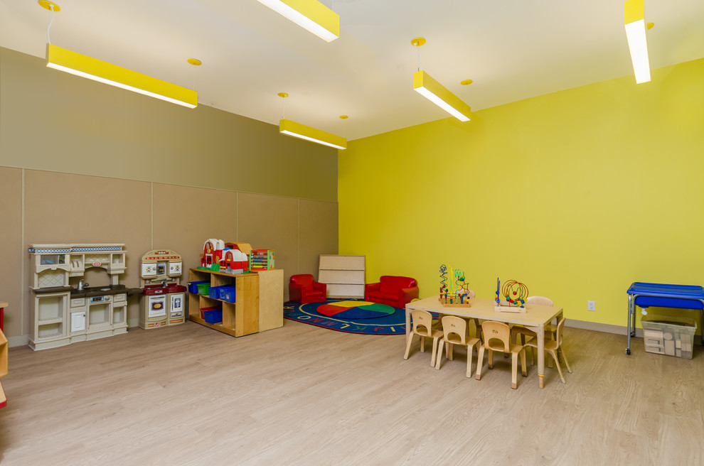 Ejemplo de dormitorio infantil de 1 a 3 años actual pequeño con paredes amarillas, suelo laminado y suelo beige