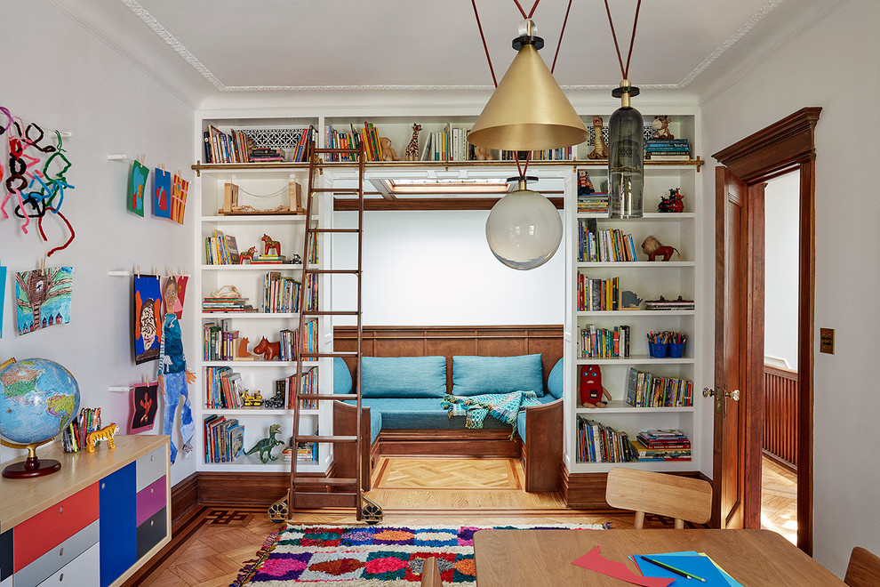Cette photo montre une grande chambre neutre de 4 à 10 ans chic avec un mur blanc, un sol en bois brun et un bureau.