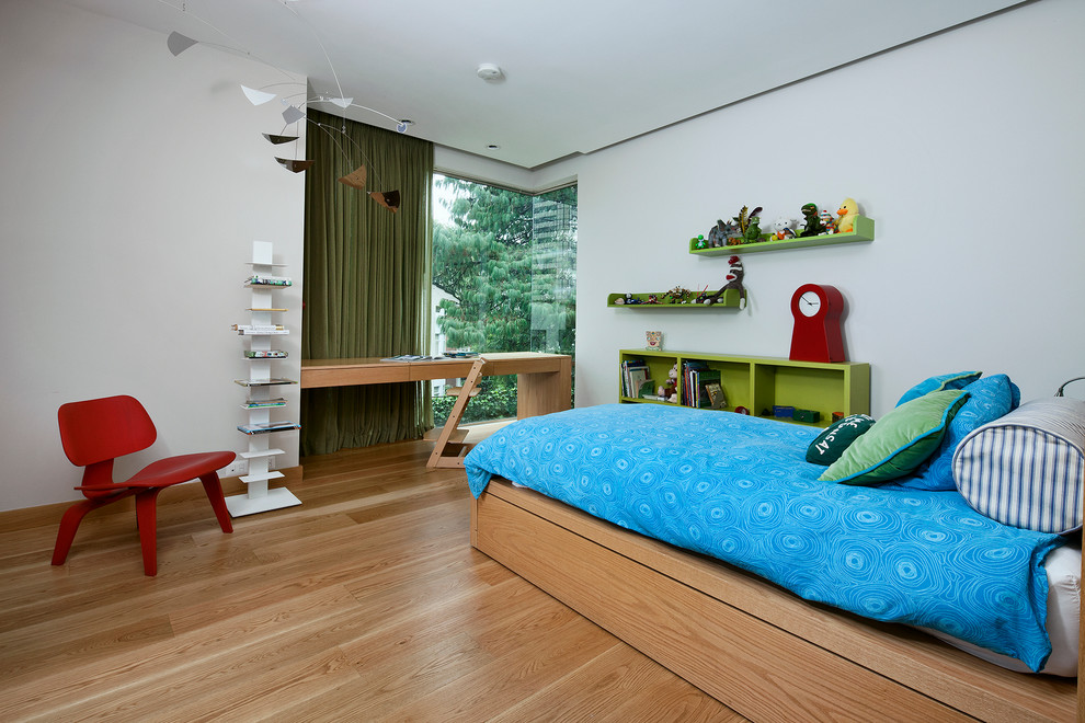 This is an example of a contemporary children’s room for boys in Mexico City with white walls and light hardwood flooring.