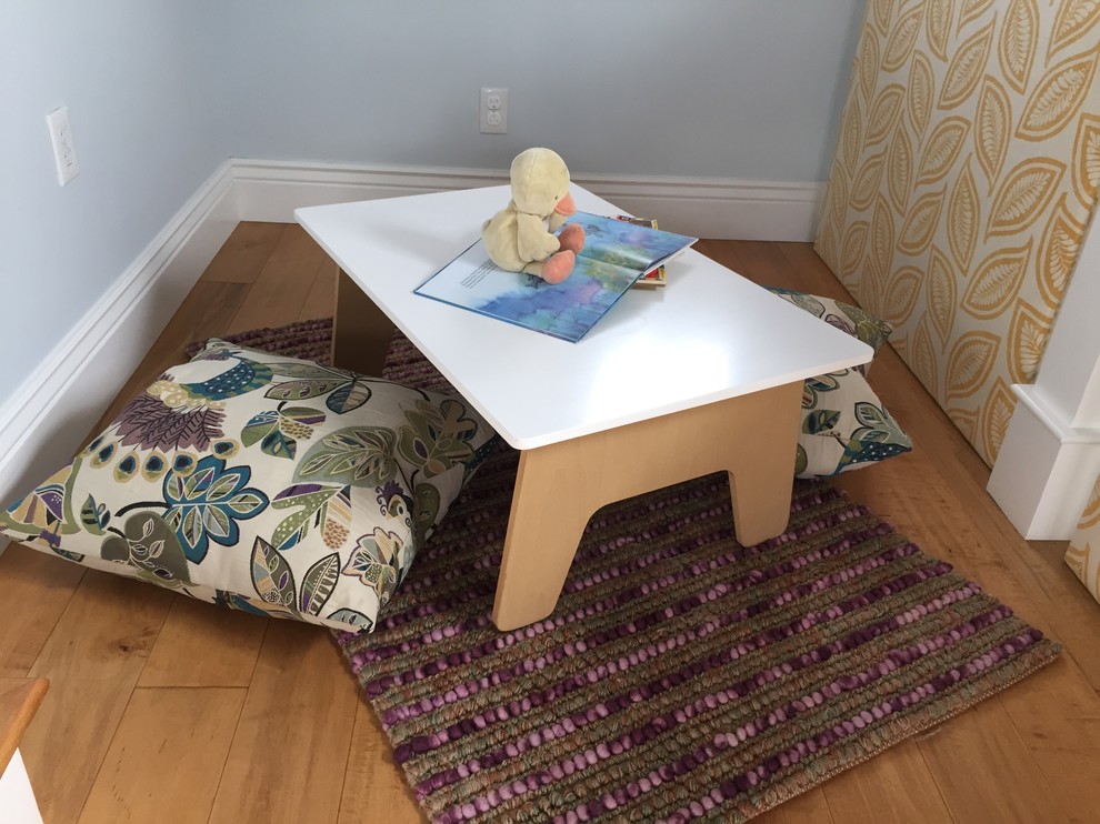 Example of a mid-sized beach style medium tone wood floor playroom design in San Francisco with blue walls