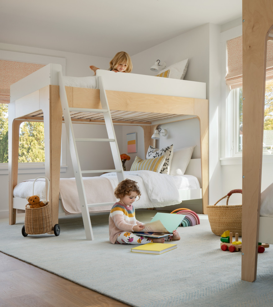 Imagen de dormitorio infantil costero con paredes blancas, suelo de madera en tonos medios y suelo marrón