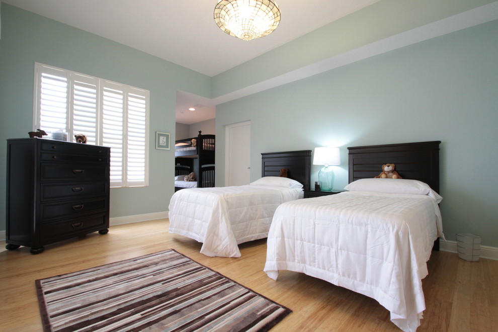 Mid-sized beach style gender-neutral light wood floor and brown floor kids' room photo in Tampa with blue walls