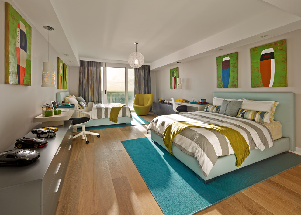 Cette photo montre une chambre d'enfant tendance avec un mur gris, un sol en bois brun et un sol beige.