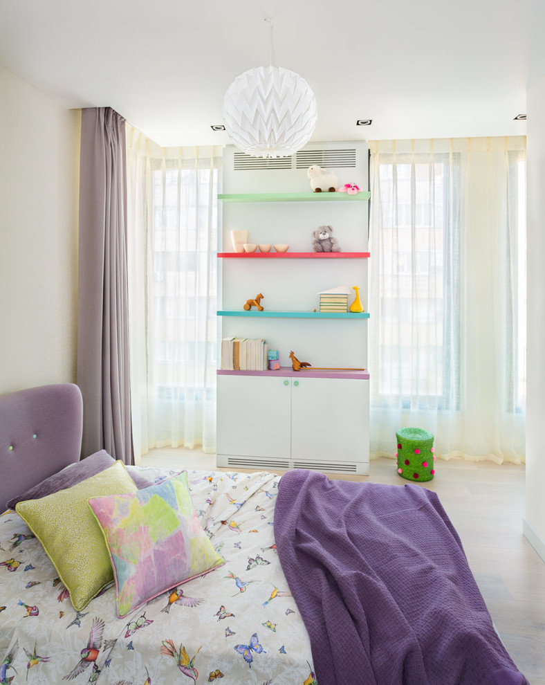 Exempel på ett modernt flickrum kombinerat med sovrum, med vita väggar och ljust trägolv