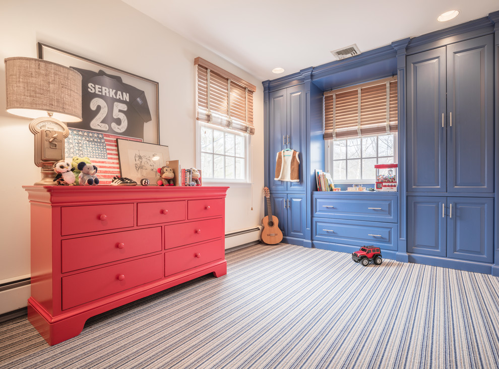 This is an example of a medium sized classic children’s room for boys in New York with multi-coloured walls, carpet and multi-coloured floors.