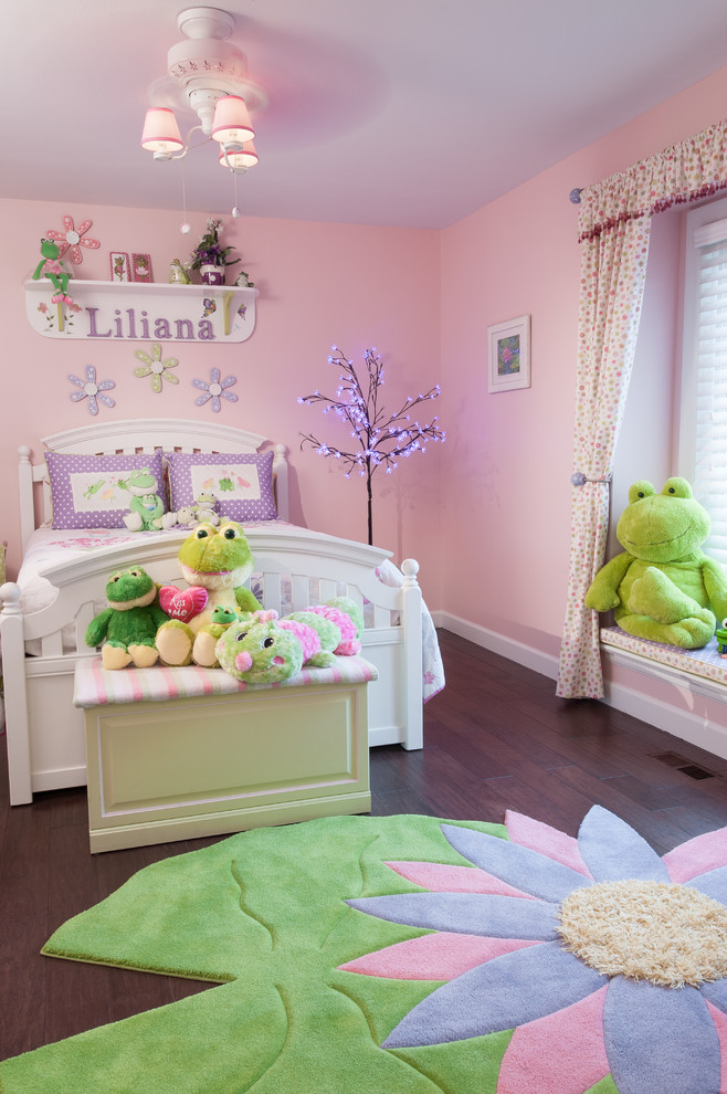 Cette photo montre une chambre d'enfant chic de taille moyenne avec un mur rose et parquet foncé.