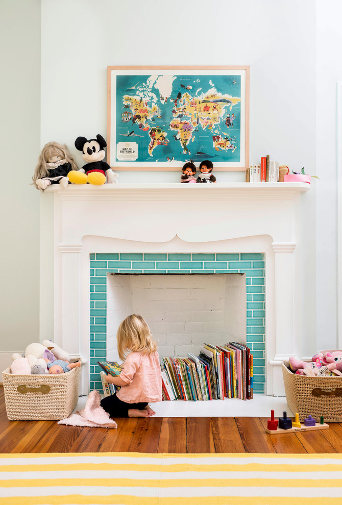Example of a classic gender-neutral medium tone wood floor playroom design in Raleigh with white walls
