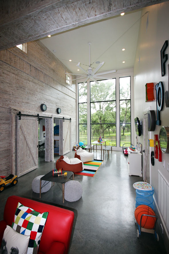 Kids' room - large contemporary gender-neutral concrete floor kids' room idea in Denver with white walls