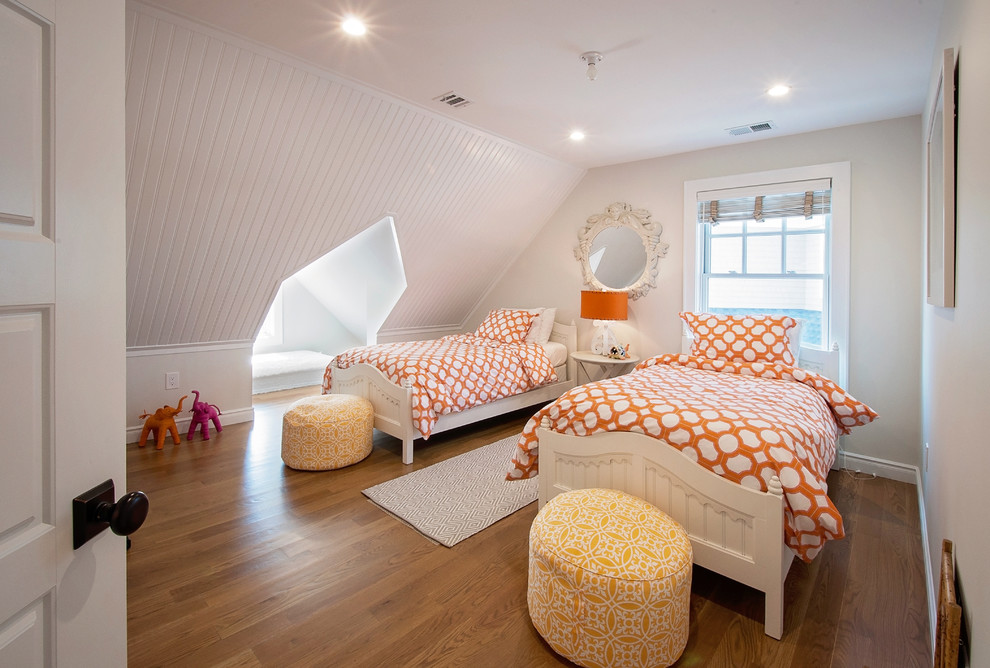 Example of a beach style medium tone wood floor and brown floor kids' bedroom design in New York with white walls