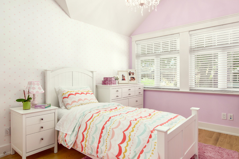 Medium sized traditional children’s room for girls in Vancouver with medium hardwood flooring and multi-coloured walls.