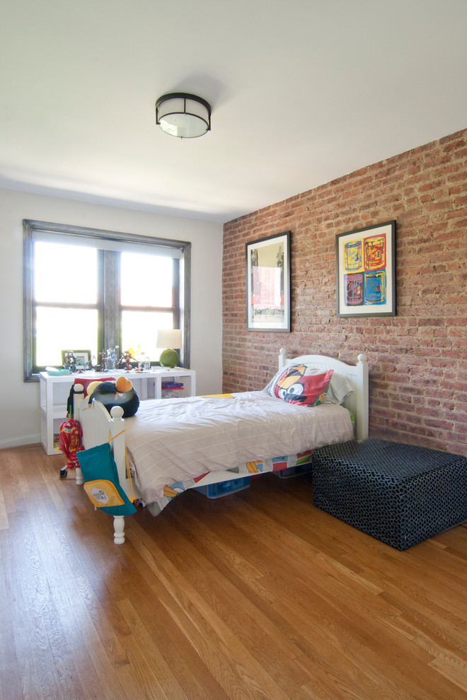 Inspiration for a medium sized urban children’s room for boys in New York with white walls, medium hardwood flooring and brown floors.