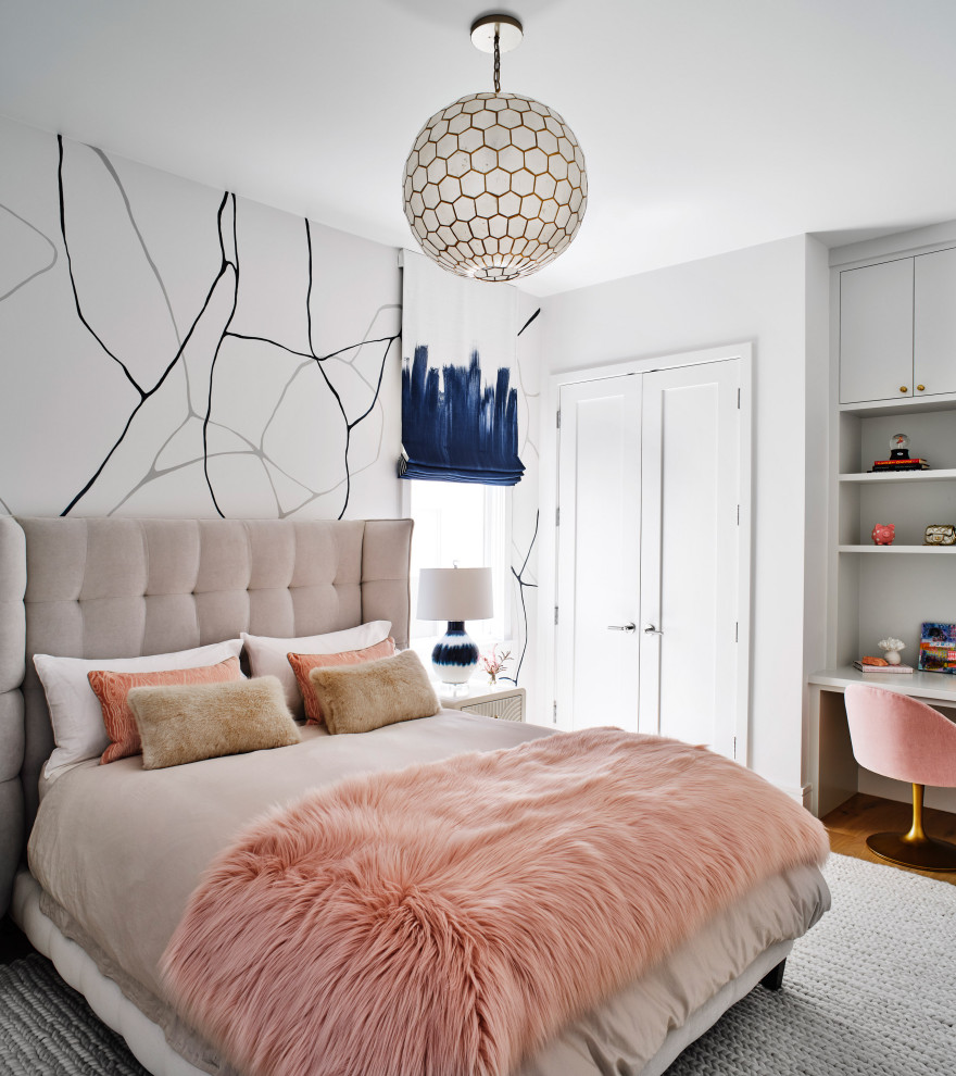 This is an example of a classic teen’s room for girls in San Francisco with white walls, medium hardwood flooring, brown floors and wallpapered walls.