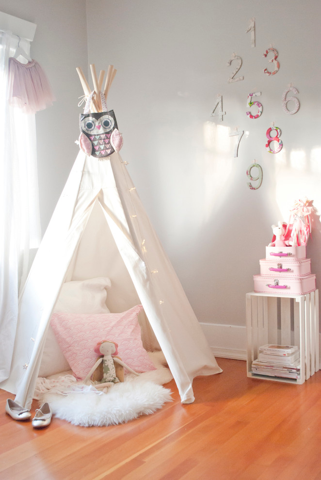 Traditional kids' bedroom for girls in Vancouver with grey walls and medium hardwood flooring.