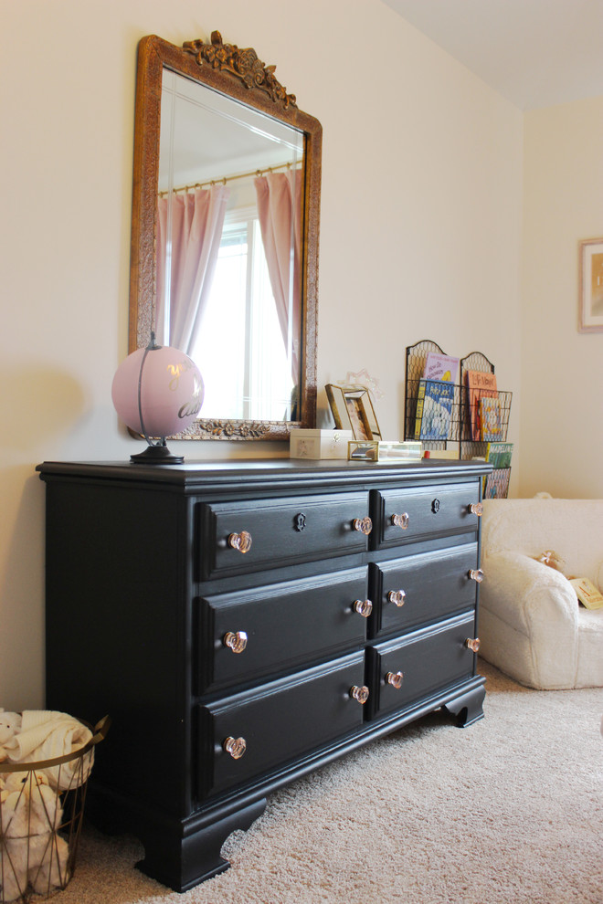 Photo of a medium sized classic toddler’s room for girls in Omaha with white walls, carpet and beige floors.