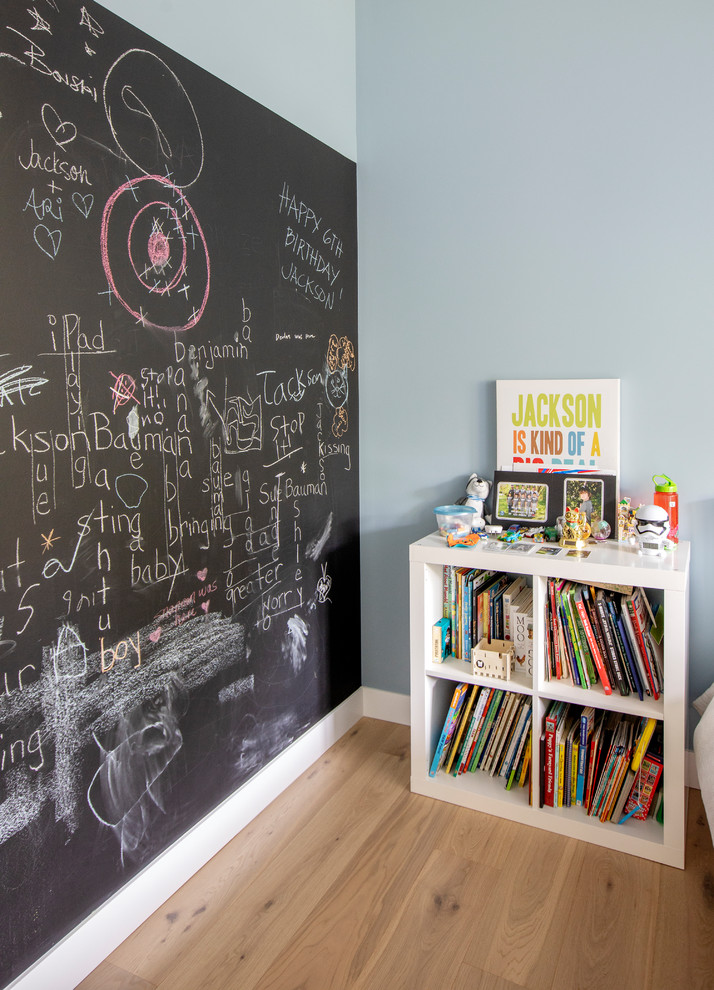Kids' room - mid-sized contemporary boy medium tone wood floor kids' room idea in Vancouver with blue walls