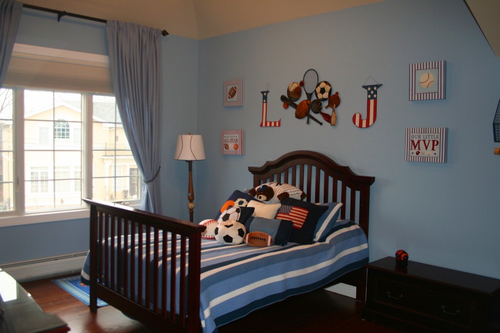 Photo of a large traditional children’s room for boys in Miami with blue walls and dark hardwood flooring.