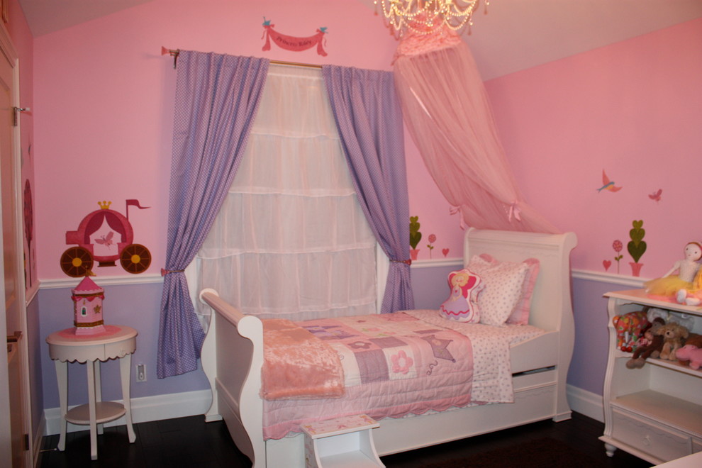 Medium sized contemporary toddler’s room for girls in Other with pink walls.