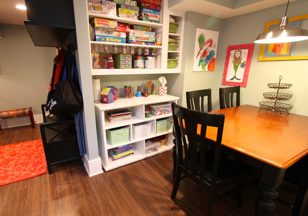 This is an example of a small traditional gender neutral playroom in Omaha with ceramic flooring and grey walls.