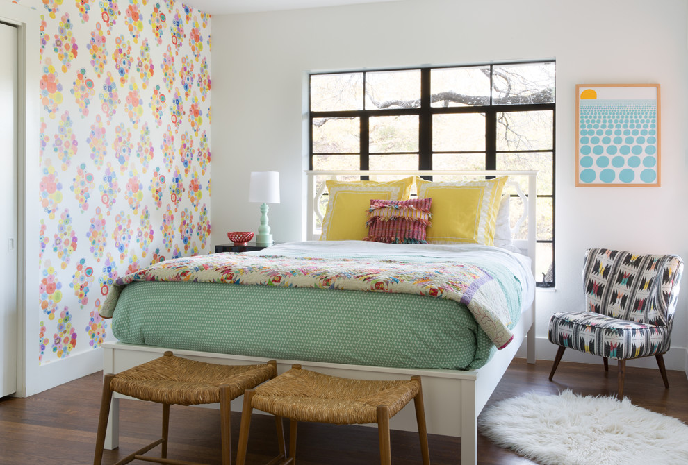 Eclectic kids' bedroom for girls in Austin with multi-coloured walls, dark hardwood flooring and brown floors.