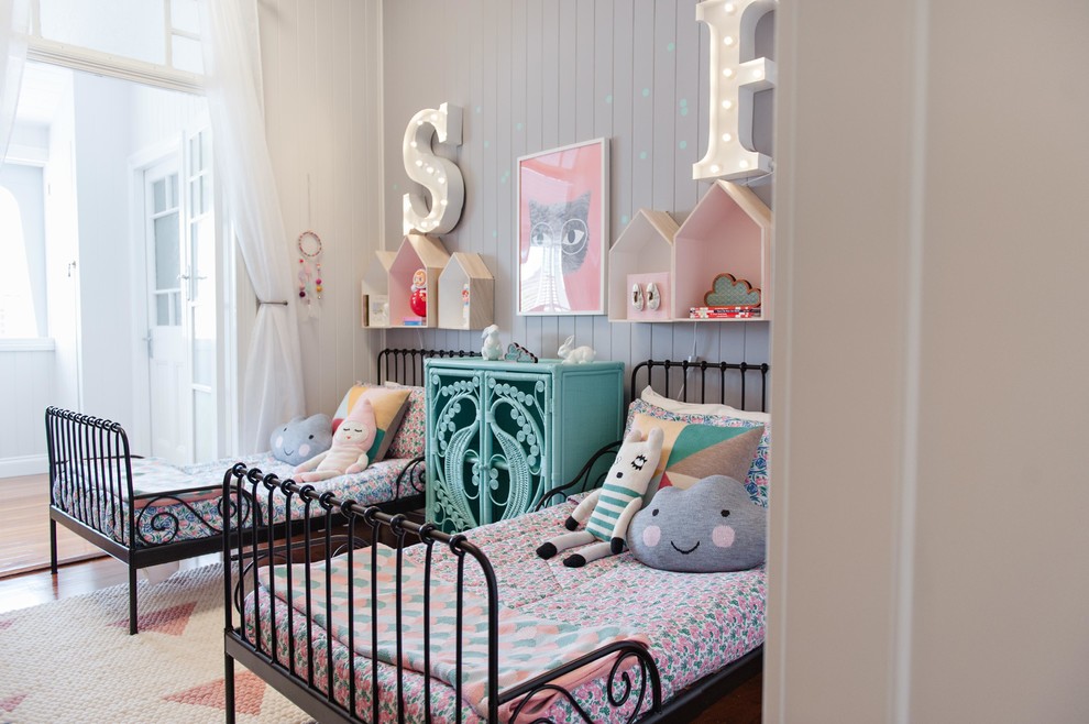 На фото: детская среднего размера с спальным местом, серыми стенами и паркетным полом среднего тона для девочки с