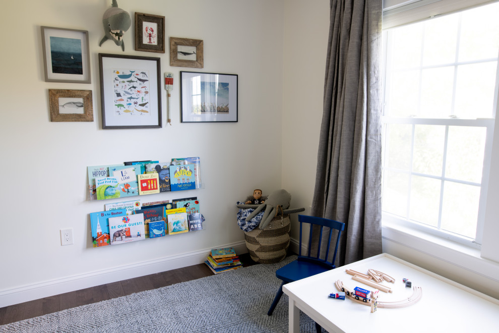 Design ideas for a medium sized bohemian toddler’s room for boys in Boston with white walls and dark hardwood flooring.
