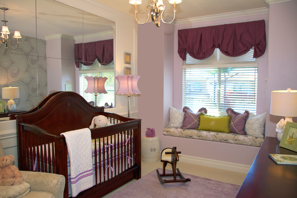 Example of a classic girl carpeted kids' bedroom design in Orange County with purple walls