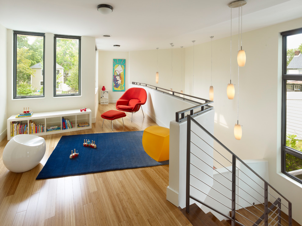 Example of a minimalist gender-neutral light wood floor and beige floor kids' room design in New York with beige walls