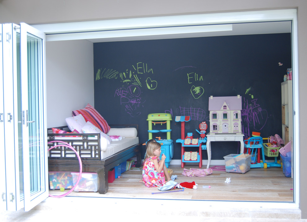 Large contemporary kids' bedroom for girls in Sydney with white walls and light hardwood flooring.