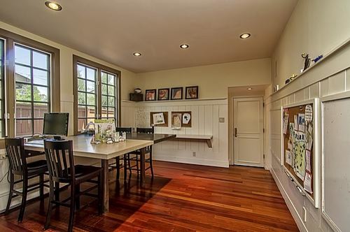 Photo of a traditional gender neutral kids' study space in Raleigh with beige walls and medium hardwood flooring.