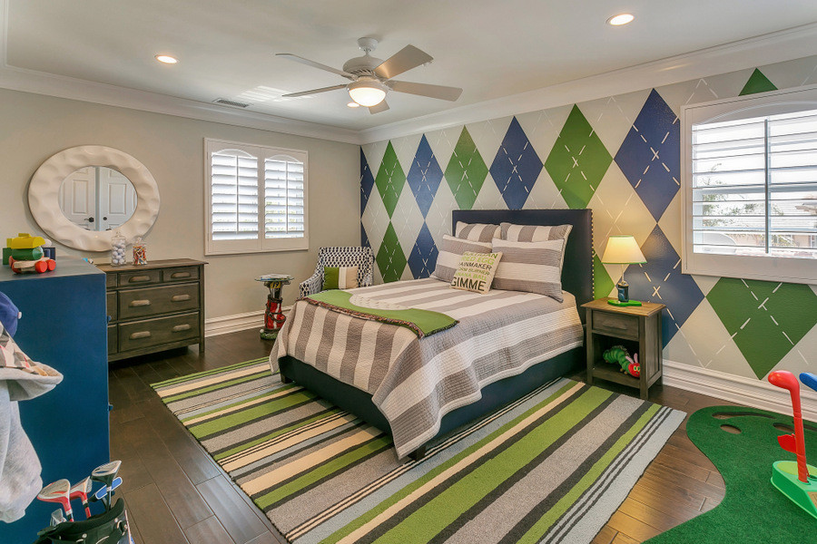 Medium sized classic children’s room for boys in Los Angeles with grey walls and medium hardwood flooring.