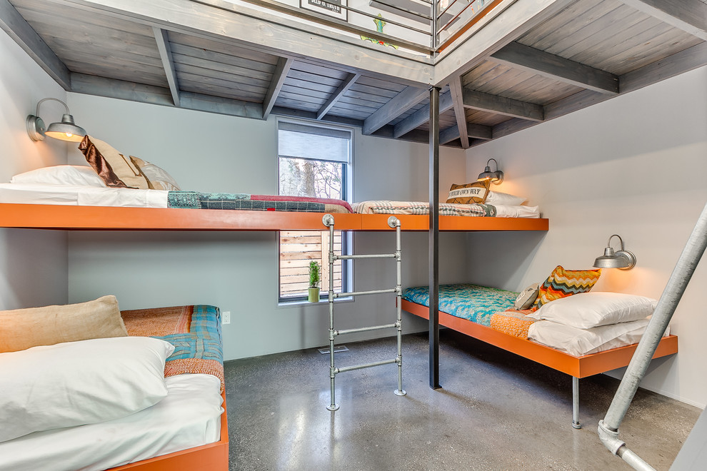 На фото: нейтральная детская в современном стиле с спальным местом, серыми стенами, бетонным полом и серым полом с