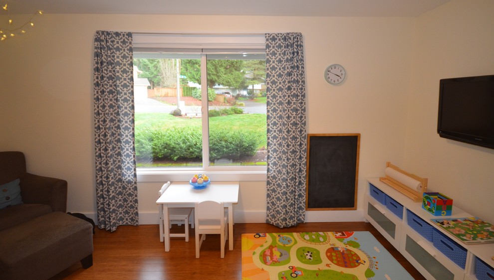 Idée de décoration pour une petite chambre d'enfant de 1 à 3 ans tradition avec un mur beige, un sol en bois brun et un sol marron.