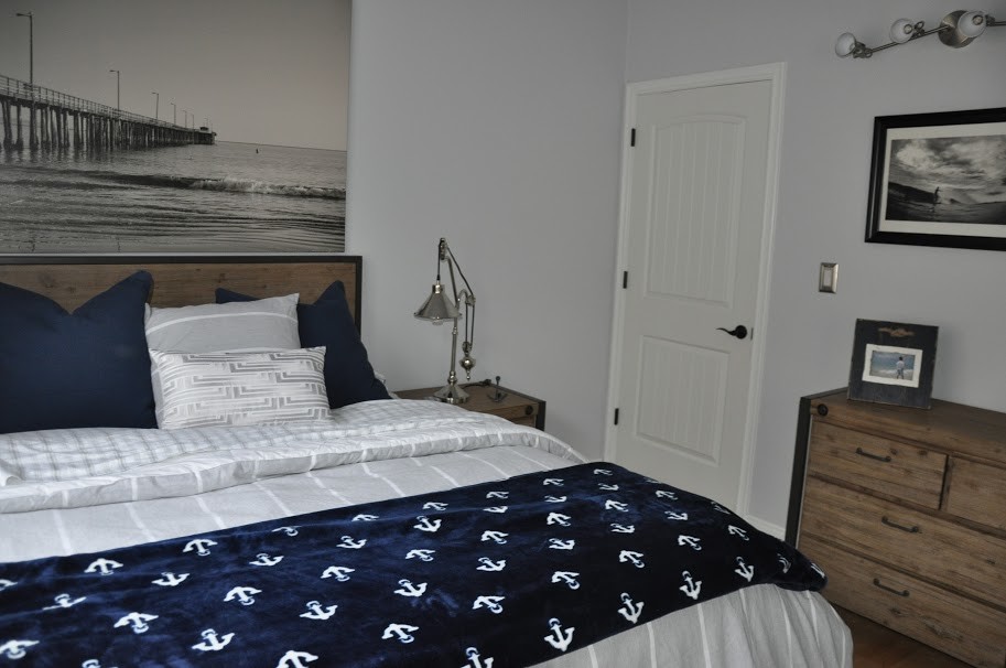 Large nautical teen’s room for boys in Los Angeles with bamboo flooring and grey walls.
