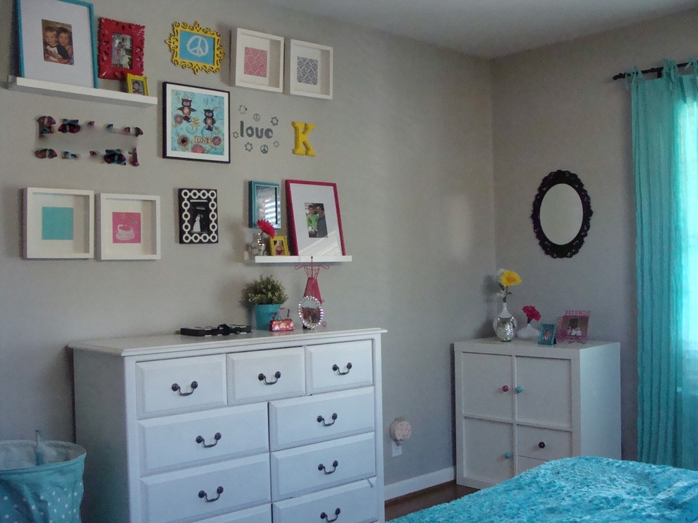 This is an example of a medium sized traditional teen’s room for girls in San Francisco with grey walls and dark hardwood flooring.