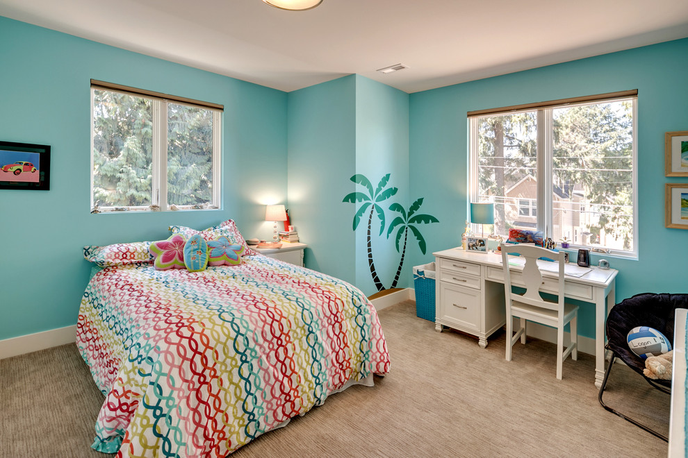 This is an example of a medium sized contemporary kids' bedroom for girls in Portland with blue walls, carpet and beige floors.