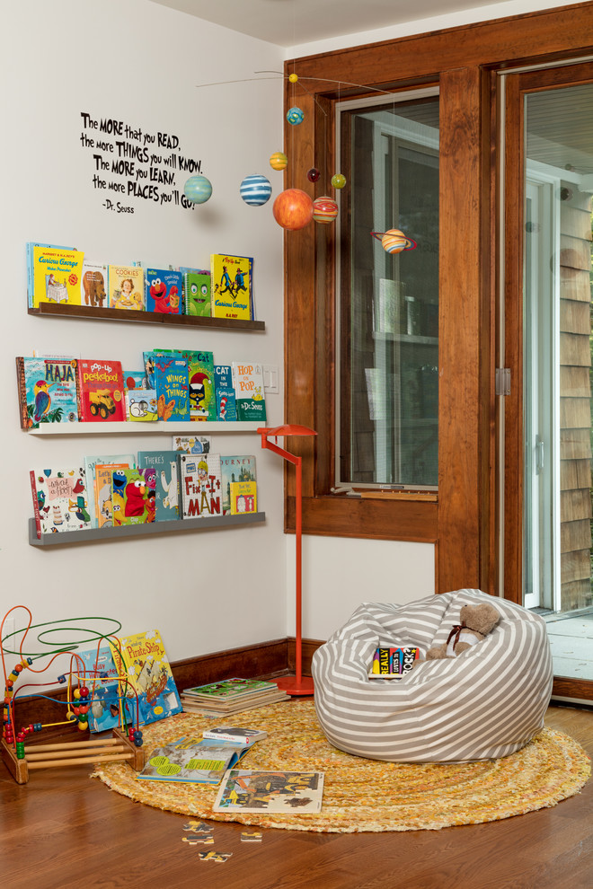 Design ideas for a classic gender neutral playroom in Other with white walls, medium hardwood flooring, brown floors and feature lighting.