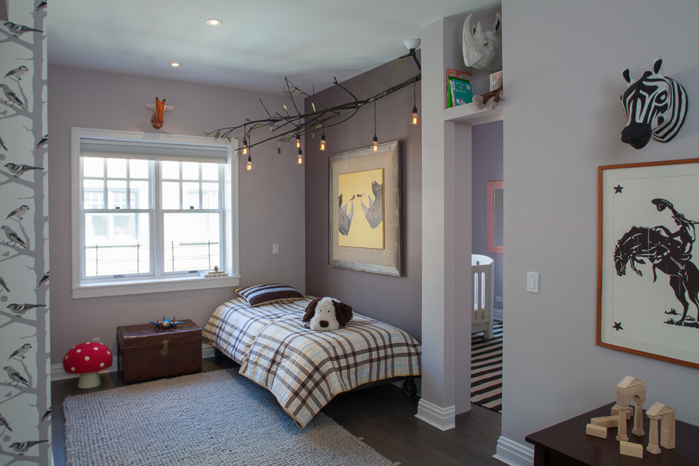 Photo of a traditional gender neutral children’s room in New York with purple walls and dark hardwood flooring.