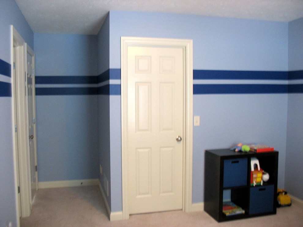 Inspiration for a timeless boy carpeted kids' room remodel in Columbus with blue walls