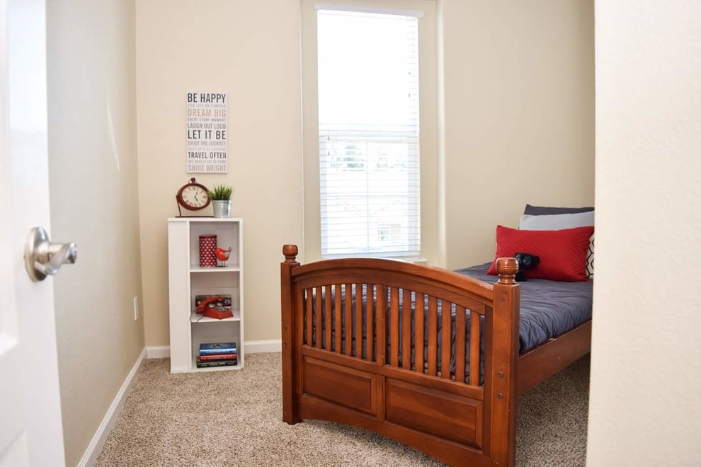 Small traditional children’s room for boys in Sacramento with beige walls, carpet and beige floors.