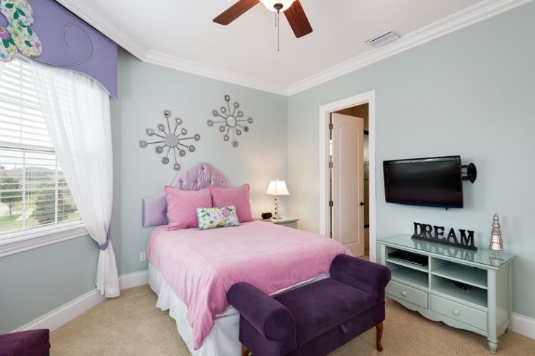 Mid-sized transitional girl carpeted and beige floor kids' room photo in Orlando with blue walls