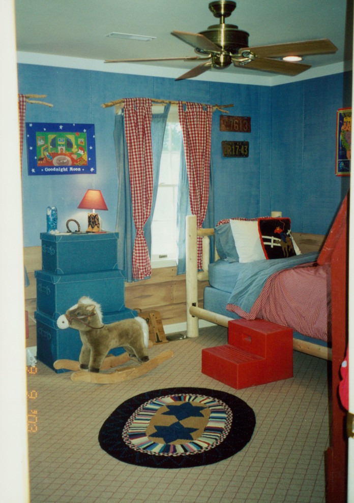 Medium sized rustic kids' bedroom for boys in New York with blue walls and carpet.