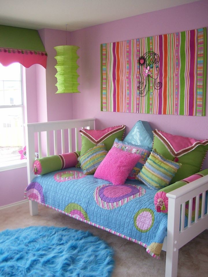Photo of a medium sized classic children’s room for girls in Austin with pink walls and carpet.