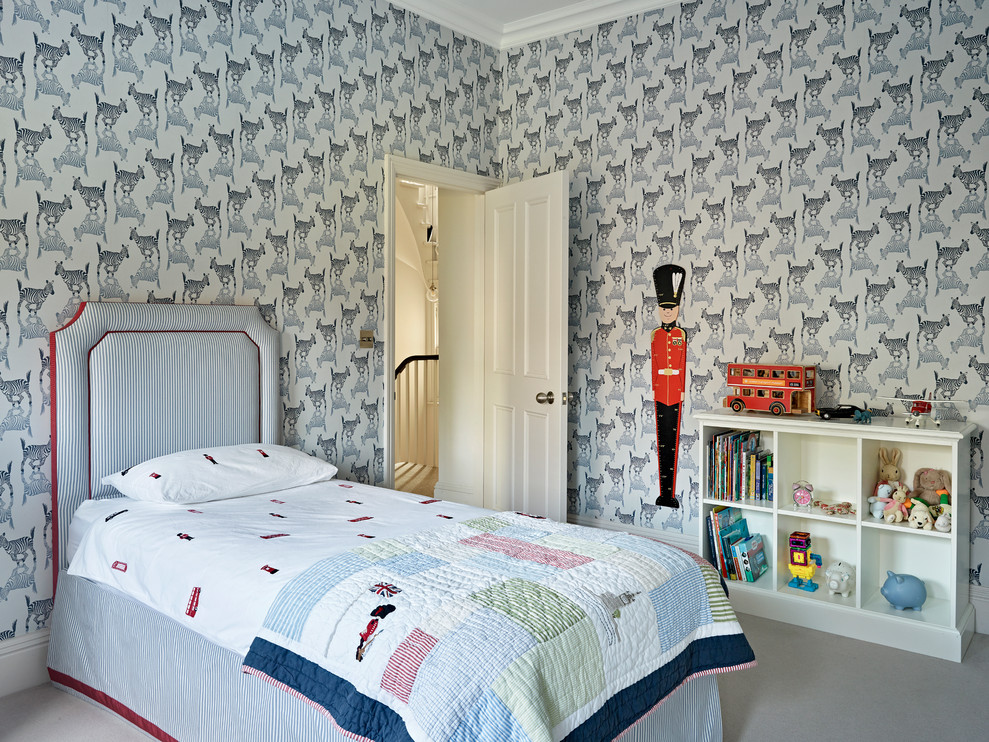 Transitional boy carpeted and gray floor childrens' room photo in London with multicolored walls