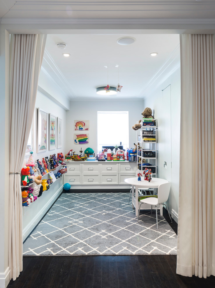Large traditional gender neutral kids' bedroom in New York with dark hardwood flooring and white walls.