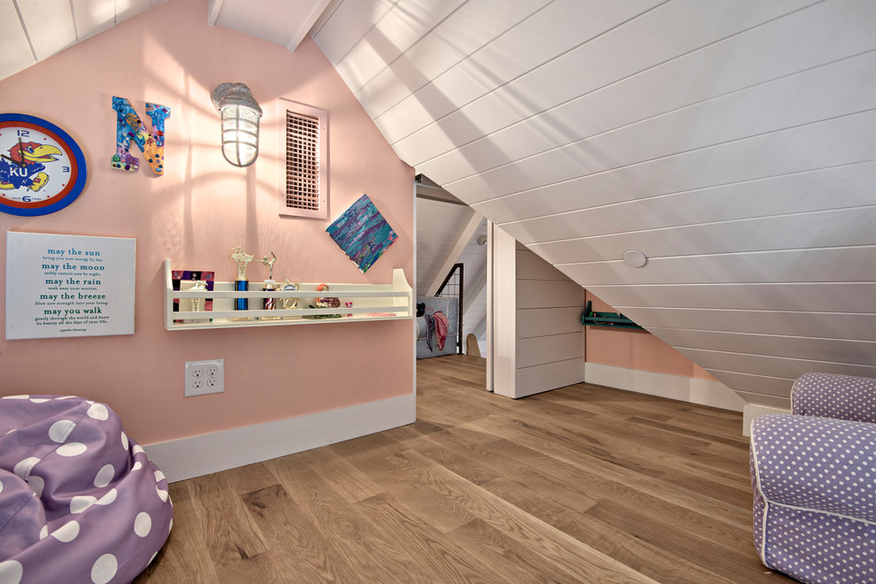 Réalisation d'une grande chambre d'enfant de 4 à 10 ans tradition avec un mur rose, parquet clair et un sol marron.