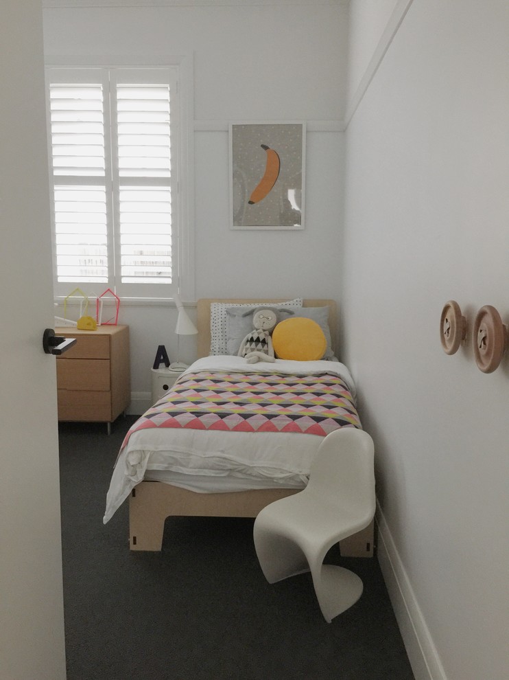 Inredning av ett modernt stort barnrum kombinerat med sovrum och för 4-10-åringar, med vita väggar och heltäckningsmatta