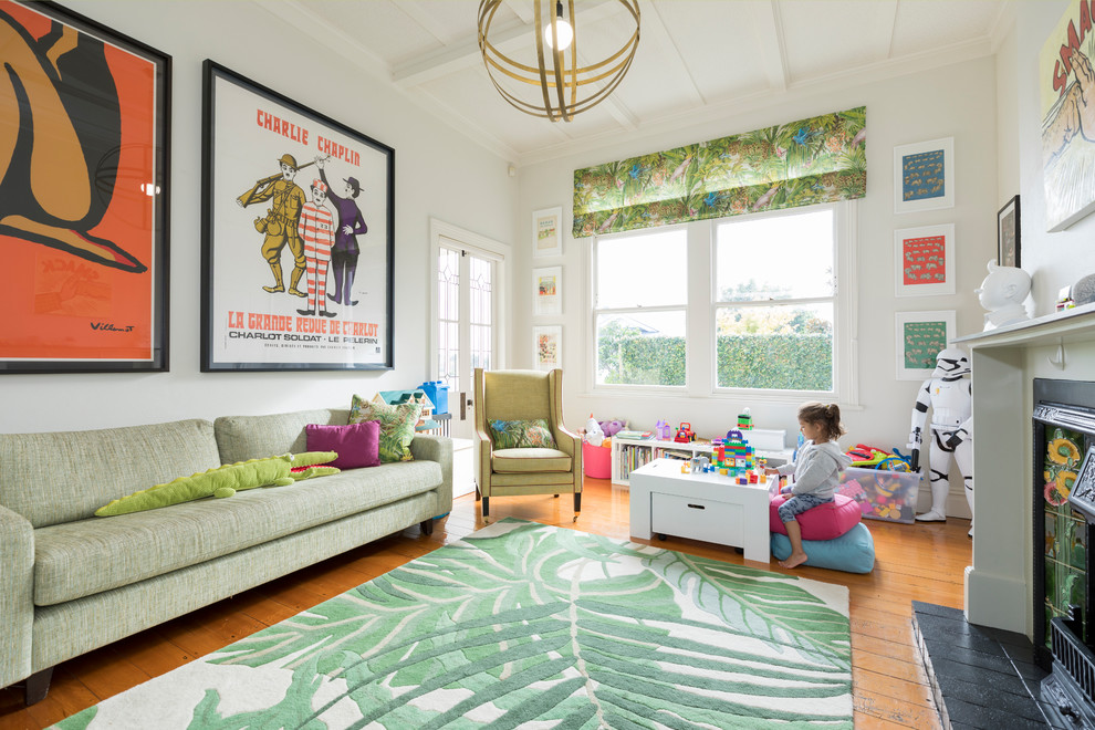 Example of a mid-sized trendy gender-neutral light wood floor kids' room design in Auckland